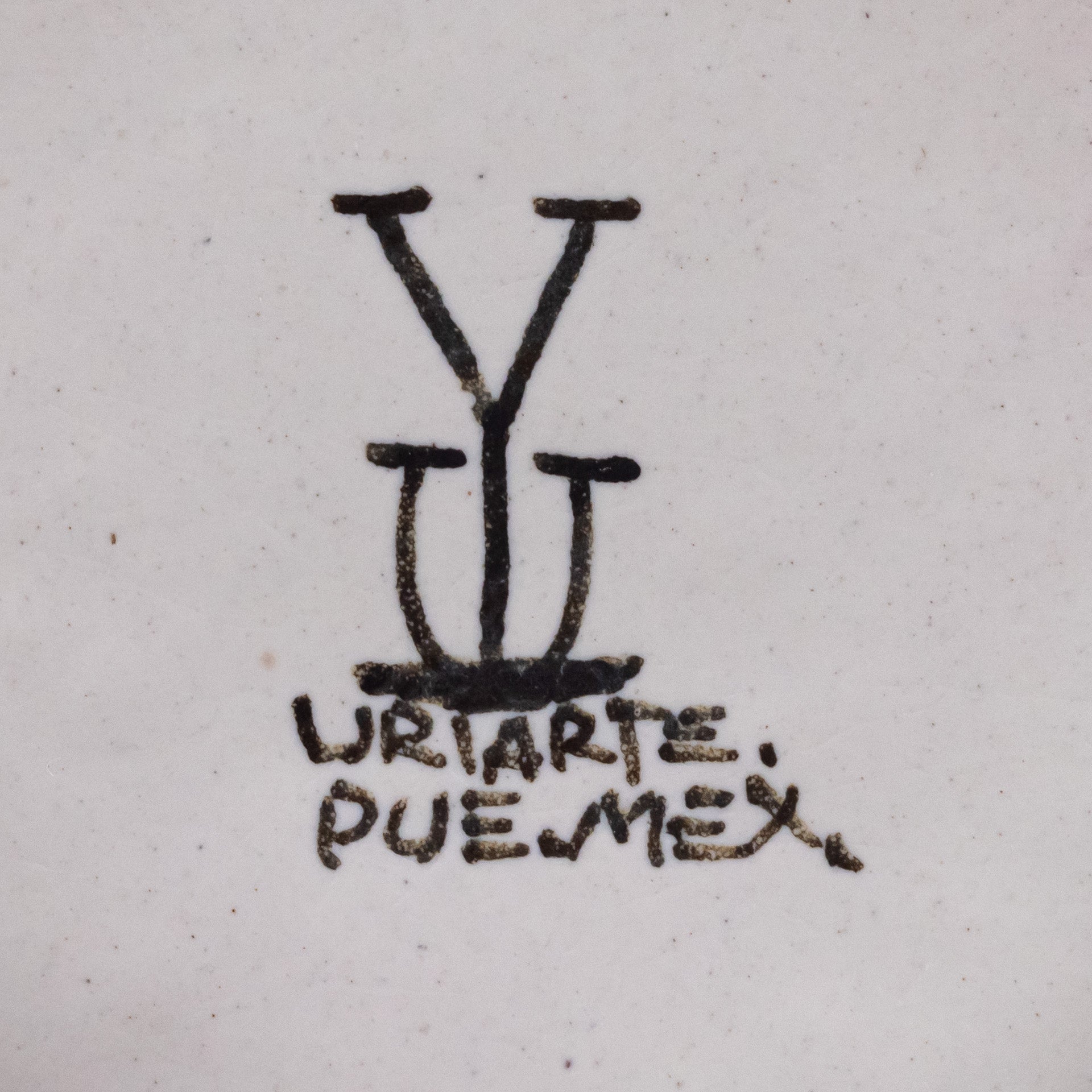 Ysauro Uriarte's monogram and text reads, "Uriarte. Pue. Mex."