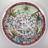 A round ceramic plate with artwork of bull fight scene in the center and spectators all around.