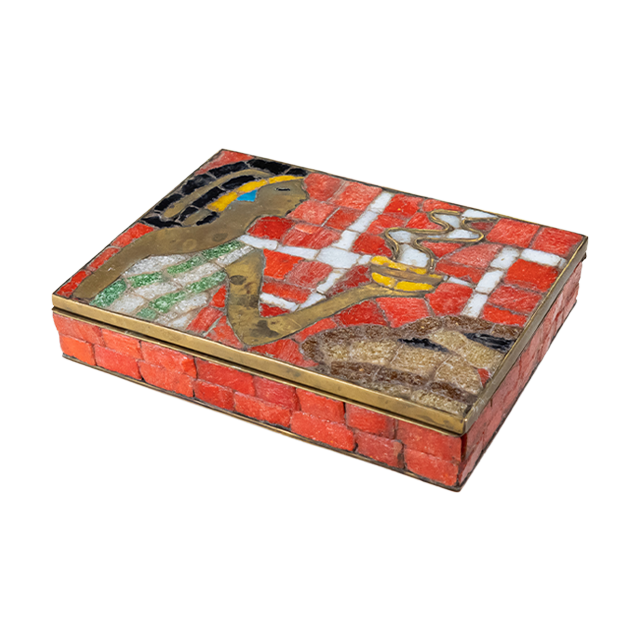 Brass box with orange glass mosaic pieces depicting an Aztec woman holding a bowl of steaming food as an offering.