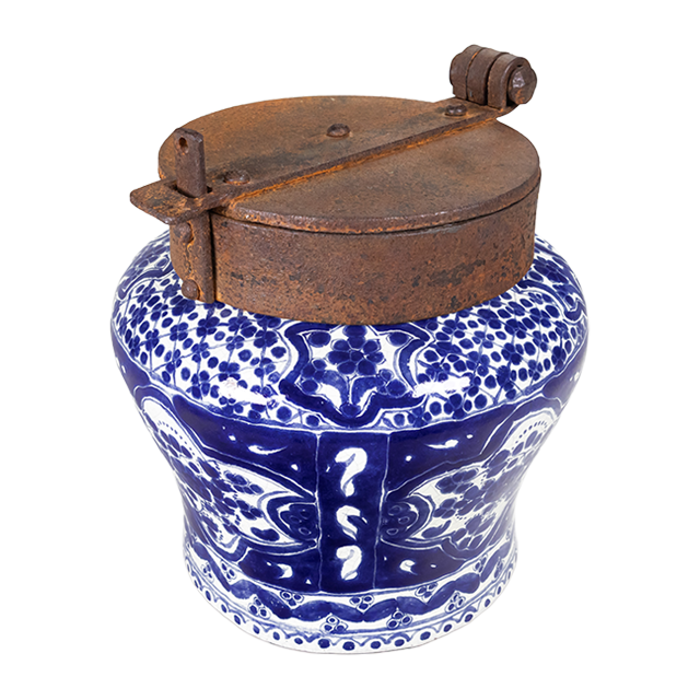 A classic cobalt blue and white talavera piece with an iron lid.
