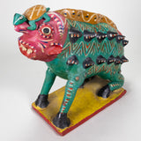 Nagual pottery figure with a human-like face, sharp teeth, and a green animal body with spikes coming out on the side, hooves, and a turtle on its head.