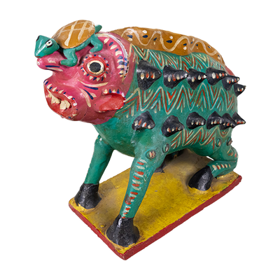 Nagual pottery figure with a human-like face, sharp teeth, and a green animal body with spikes coming out on the side, hooves, and a turtle on its head.