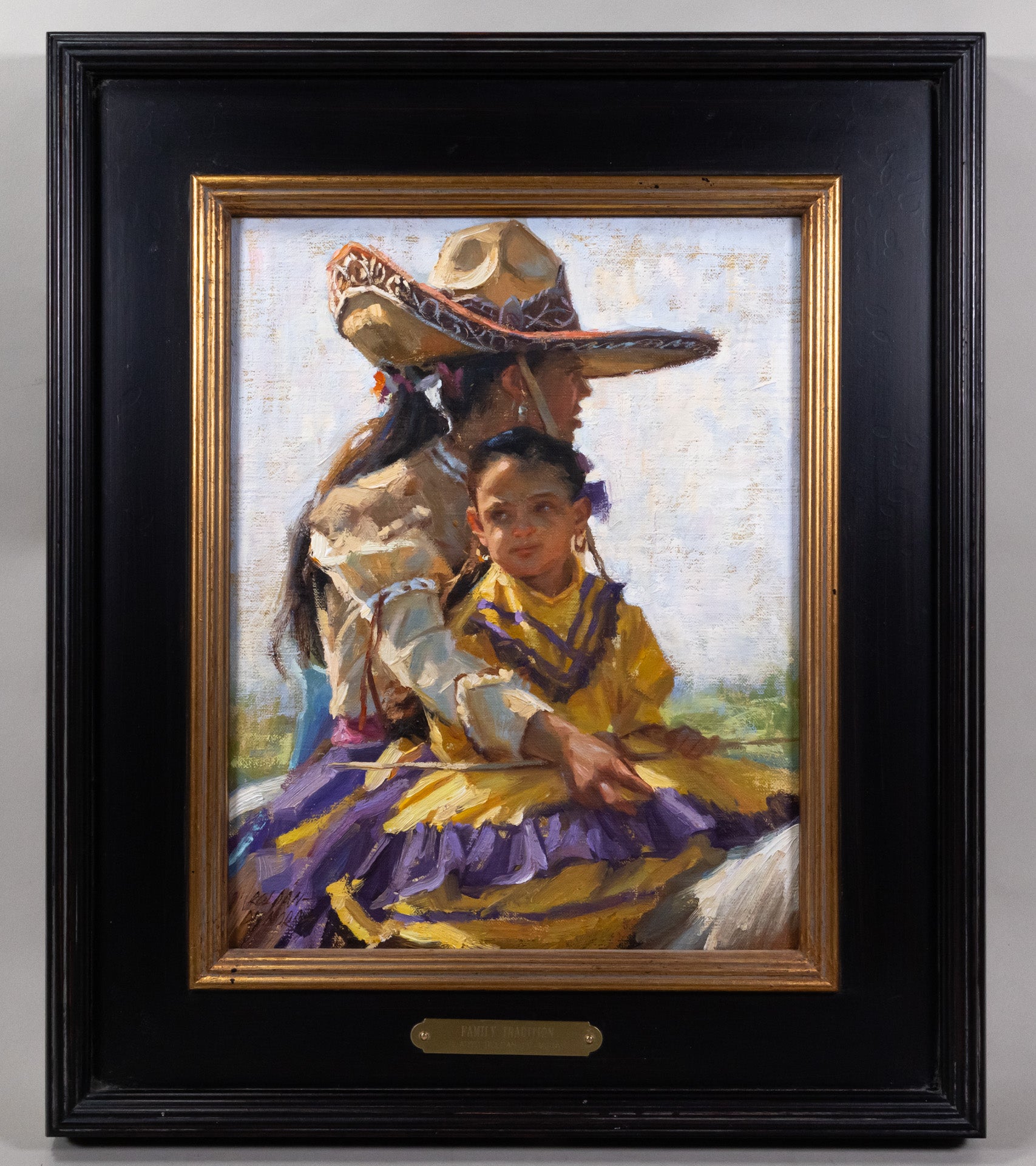 Framed oil painting of a mother dressed in a traditional equestrian outfit with her cowboy hat, on a horse with her daughter who's wearing a yellow and purple dress.