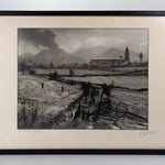 Framed black and white photograph of the Eruption of Parícutin with the Church of San Juan Parangaricutiro in the background.