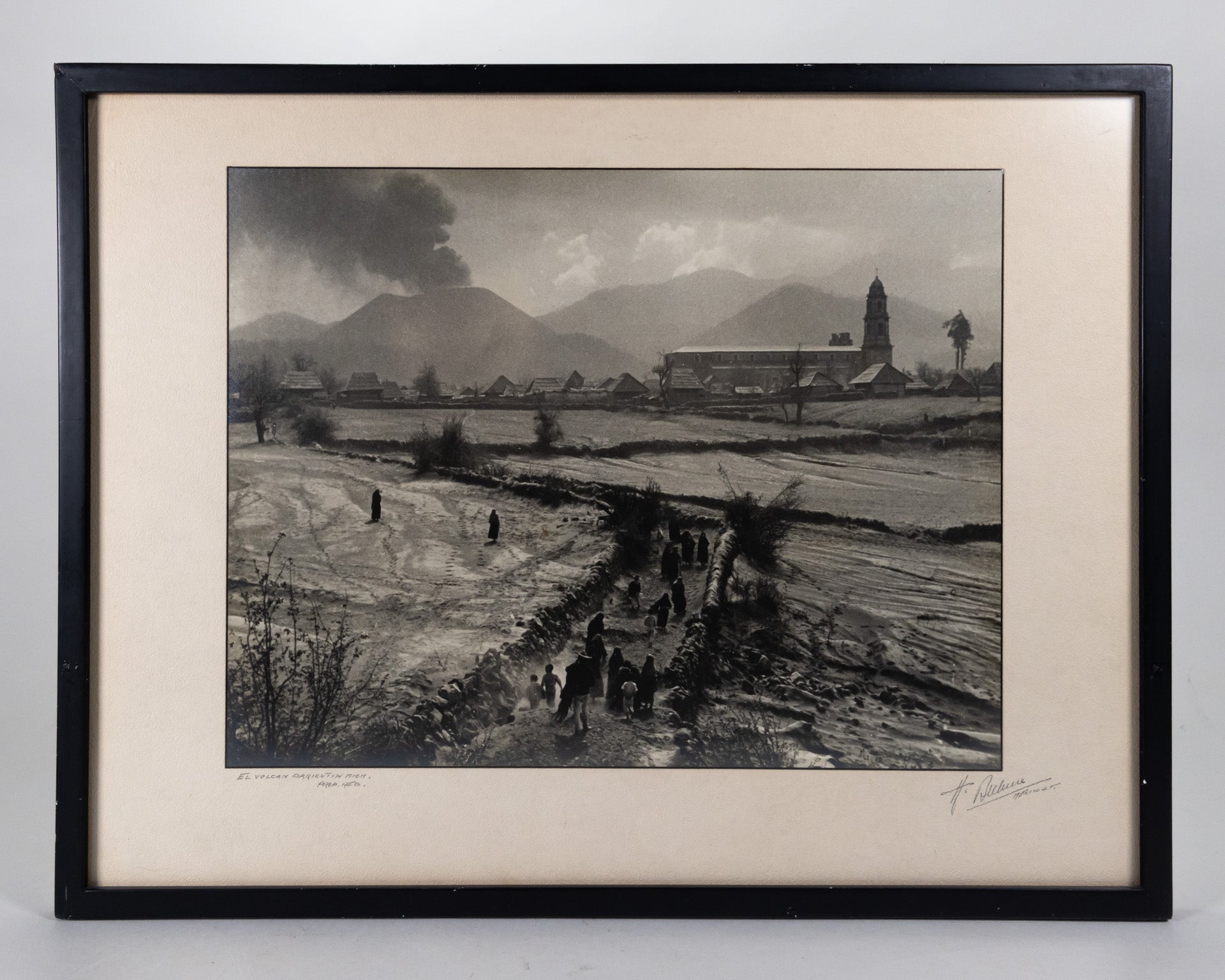 Framed black and white photograph of the Eruption of Parícutin with the Church of San Juan Parangaricutiro in the background.