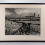 Framed black and white photograph of the Eruption of Parícutin with the Church of San Juan Parangaricutiro in the background.