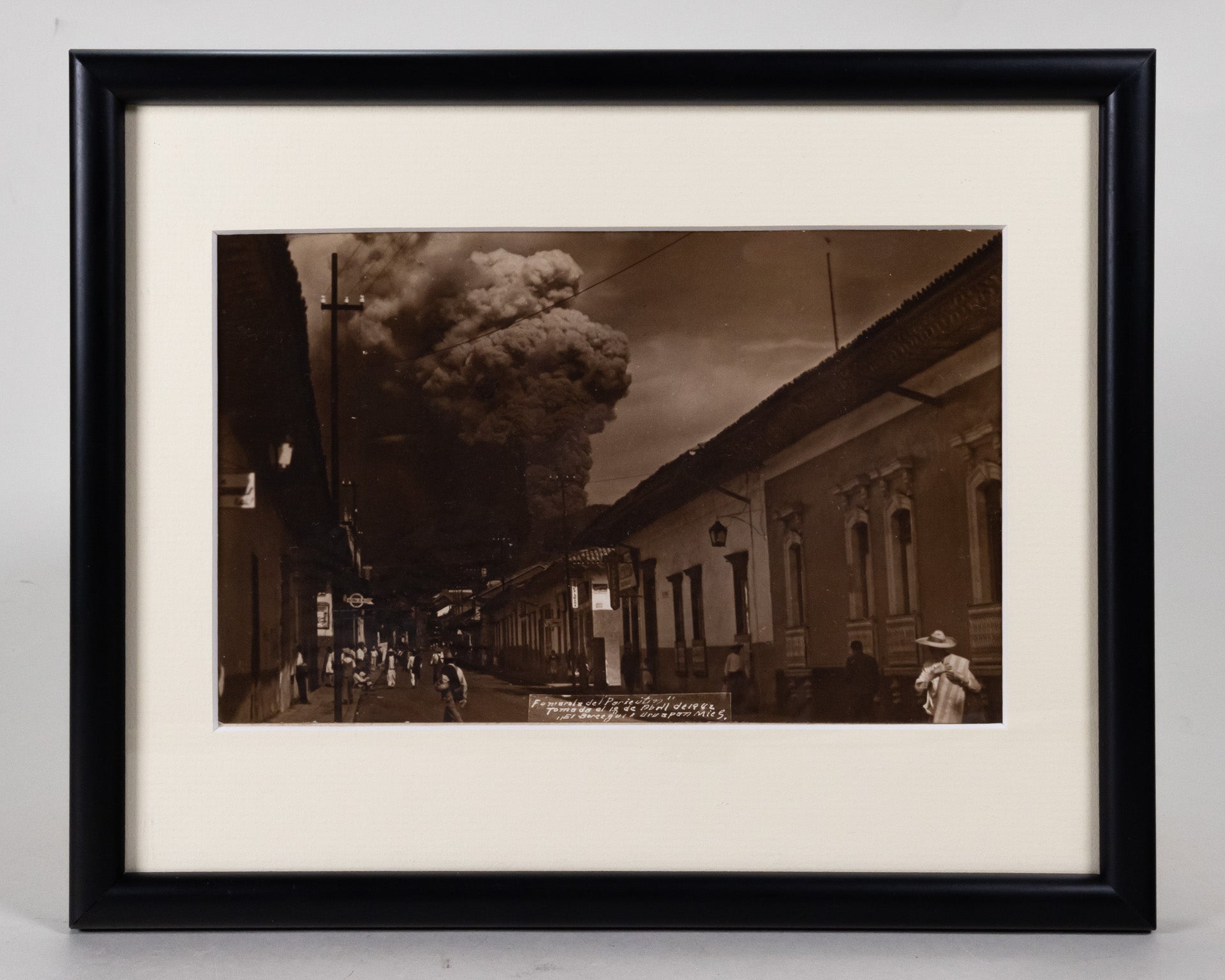 Framed sepia photograph of the eruption of Parícutin, taken in the streets of Uruapan.